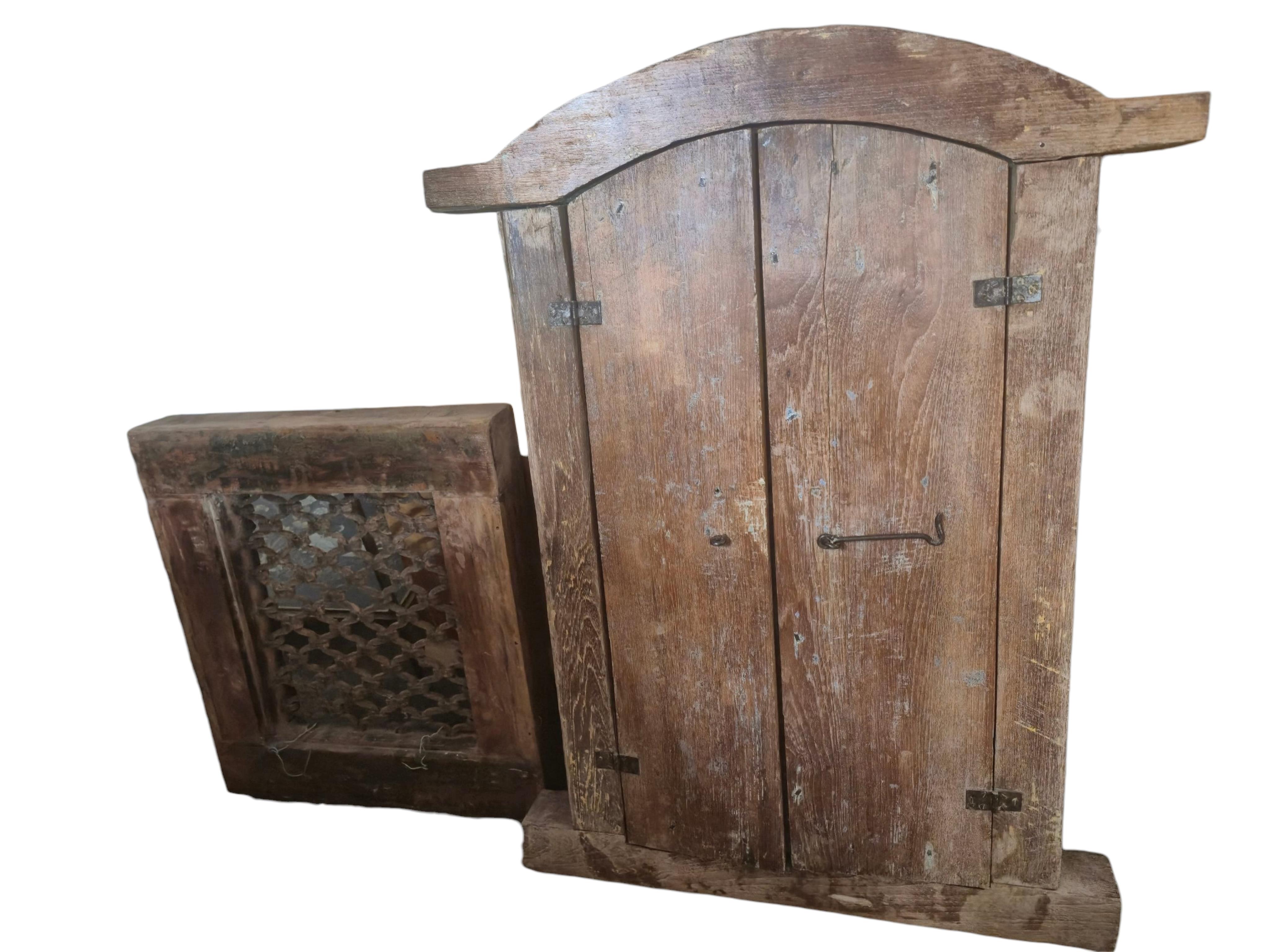 Two Indian hardwood and iron grilled window panels